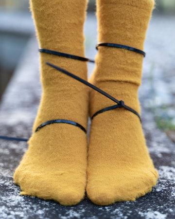 A closeup of tied female legs in thick socksの写真素材