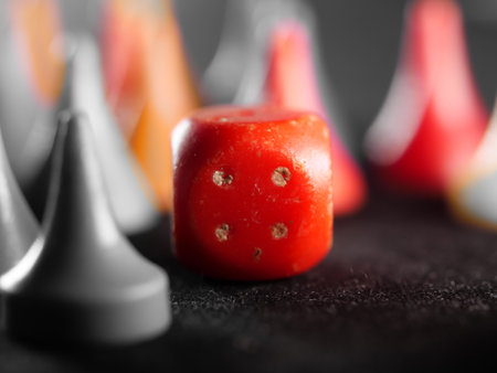 A red dice for board games on the tableの写真素材