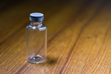 A closeup shot of an empty container on a wooden table - covid19 conceptの写真素材