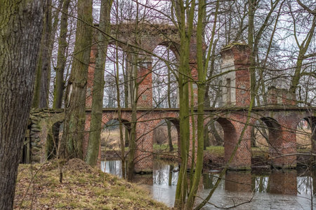 An ancient stone viaduct in a forestの写真素材
