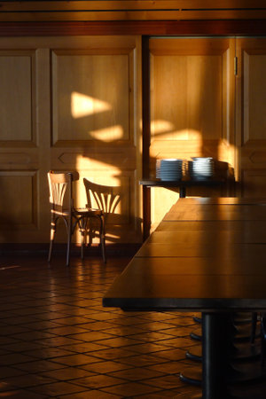 Empty restaurant wooden interior with table, chair and dishes (vertical format)