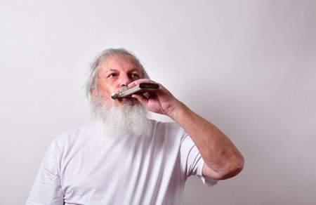 An old alcoholic male drinking booze from a flask