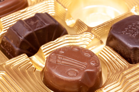 A box with a fresh tasty assortment of chocolate favorsの写真素材