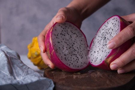 Dragon fruits cut out and exposed on dark backgroundsの写真素材