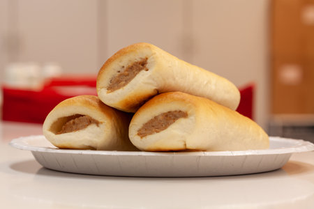 A closeup shot of tasty sandwiches on a white plate in the kitchen