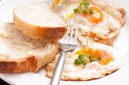 organic free range fried eggs with home made breadの写真素材
