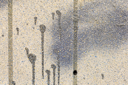 An old dirty wall with holes and paint stains on it
