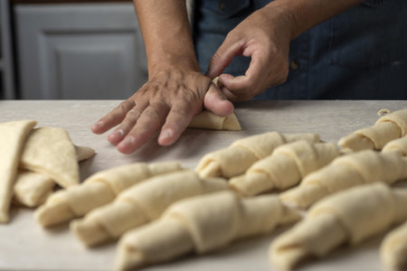A closeup shot of a person making croissants in the kitchenの写真素材