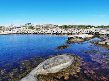 A scenic shot of a sea surrounded by stone mountains in Verdens Ende, Norway