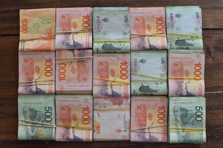 flatlay of argentine peso 500 and 1000 peso banknotes, symbol of inflation