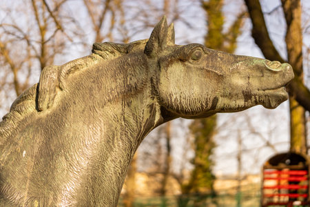 A selective focus shot of a wooden horse sculpture in a parkの写真素材