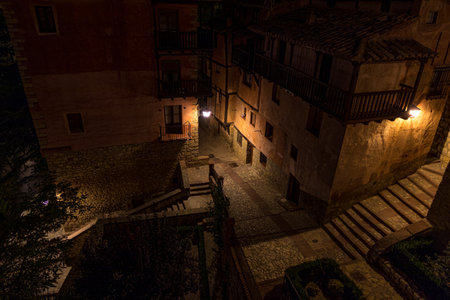 A high angle shot of an illuminated dark alleyway in Teruel, Spainの写真素材