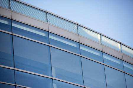 A closeup shot of a modern building under a blue sky