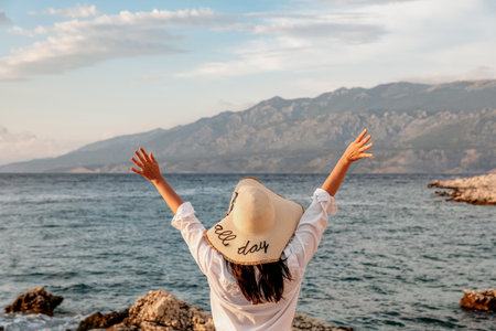 A female with a hat relaxing on a beach in Croatia