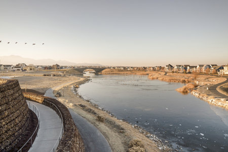 An aerial view of a frozen river in the middle of an inhabited area with buildingsの写真素材
