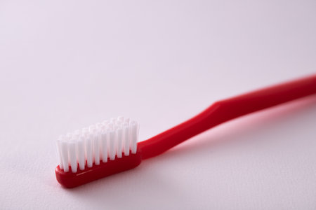 A shot of a red toothbrush isolated on white backgroundの写真素材