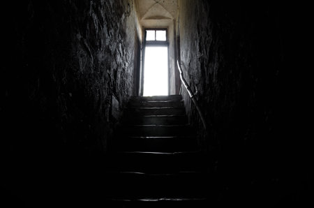 A low angle shot of a staircase to a door with sunlight in Switzerlandの写真素材