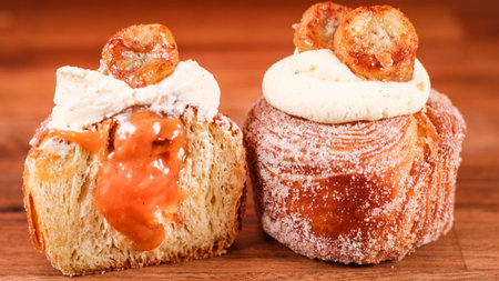 A closeup of puff pastry covered with sugar and topped with creamの写真素材