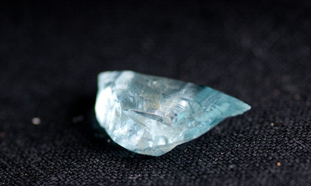 vibrant blue clrea beryl crystal mineral sample on black backgroundの写真素材