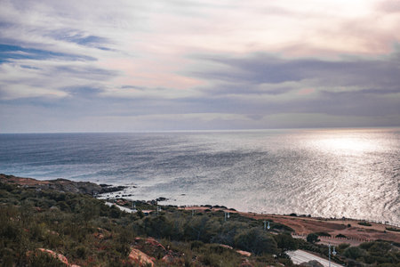 A stunning sunset view of the coast under a soft cloudy beautiful skyの写真素材