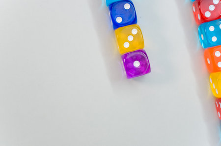 A top view of colorful transparent dice on white background for a copy space
