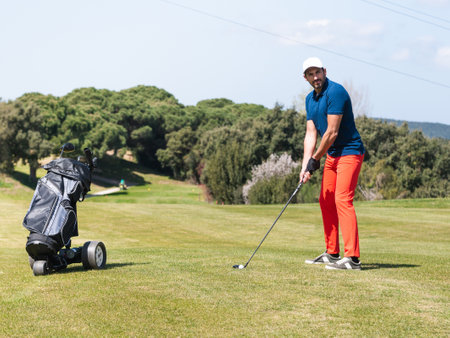 A young Caucasian male playing golf on a professional golf courseの写真素材