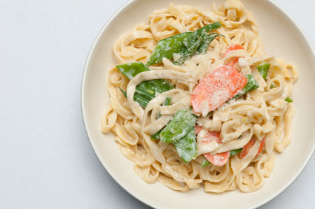 fettuccine alfredo primavera, creamy sauce with vegetables and home made pastaの写真素材