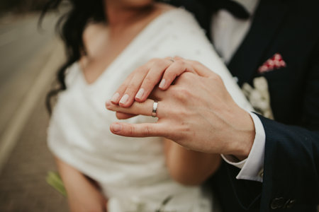 A selective focus shot of a bride and groom holding handsの写真素材