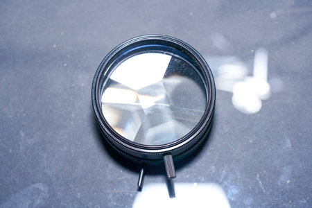 A closeup of magnifying glass on a glass crystals on the tableの写真素材