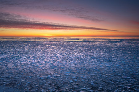 A closeup shot of sunset colors on the sky and clouds on a frosty winter day