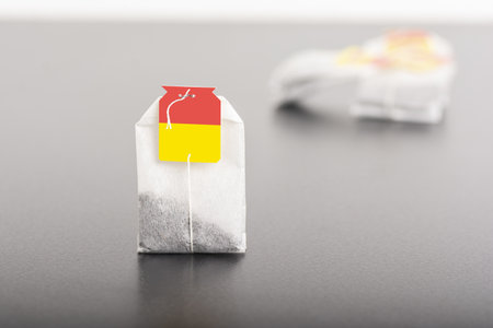 A porous teabag on dark table background, editable mock-up series template ready for your designの写真素材