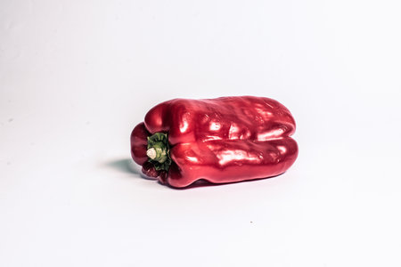 A closeup shot of red bell pepper on a white isolated backgroundの写真素材