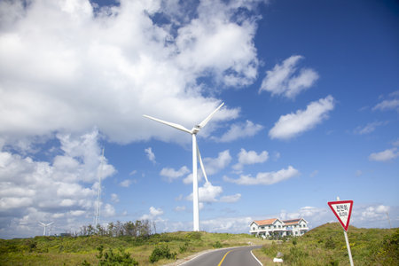 A rural area with wind turbines and a cloudy sky