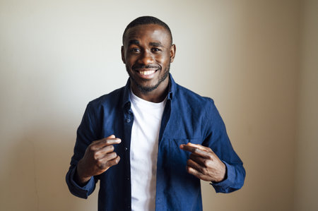 A closeup shot of a smiling black male showing hand gestures - happiness conceptの写真素材