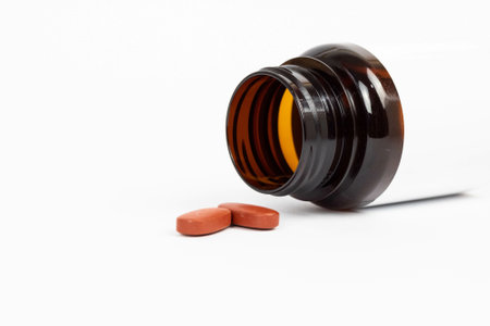 A selective focus of  a container with pills on a white surfaceの写真素材