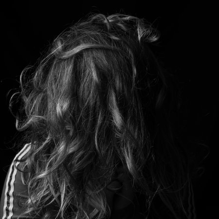 A vertical grayscale shot of a female's messy hairの写真素材