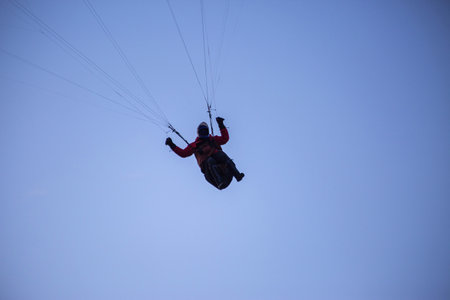 A paraglider on blue sky backgroundの写真素材