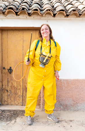 A vertical shot of a female wearing a chemical protective suit with a mask and toolsの写真素材