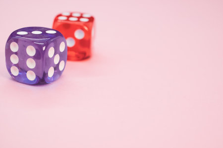 Two purple and red dices isolated on pink backgroundの写真素材