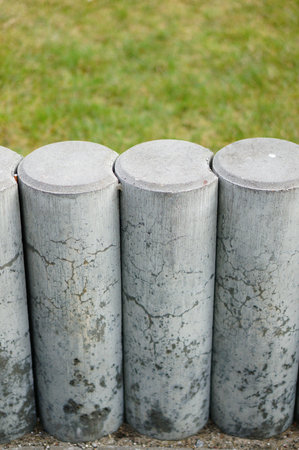 Low stone barrier and green grassの写真素材