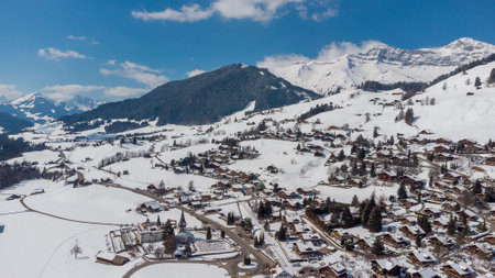 A beautiful aerial winter landscape of the snow-capped village of Rougemont, Switzerlandの写真素材