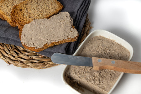 A closeup of the sliced bread covered with the delicious vegan mushroom and walnut pate