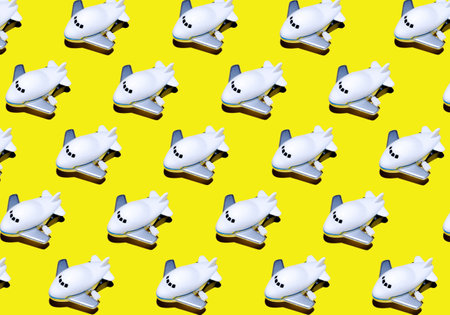 A group of airplanes isolated on yellow background.Travel on summer vacationの写真素材