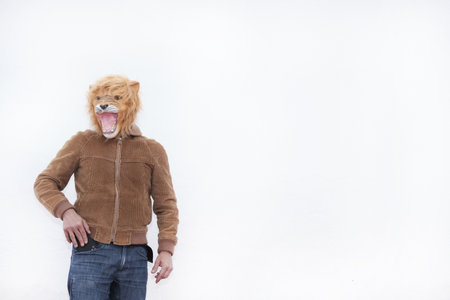 A man with a roaring lion full mask posing for camera isolated on white background