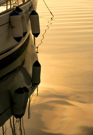 The reflection of ship ballast weight bags on the golden waterの写真素材