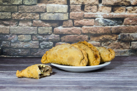 Typical Argentine fried meat empanadas, on rustic backgroundの写真素材