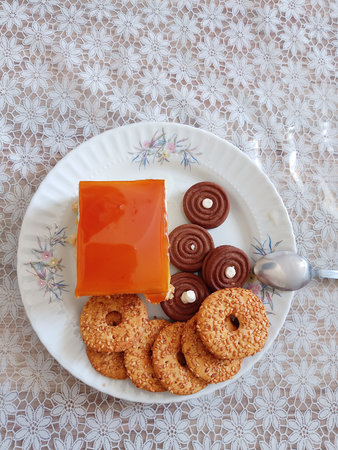 A top view of a cake and cookies on a plate