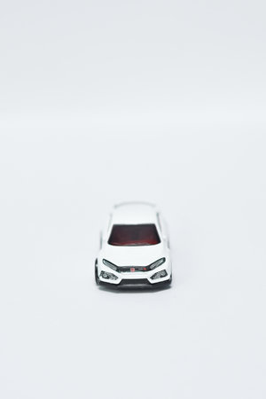 A vertical shot of a small white car figure on an isolated backgroundの写真素材