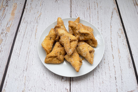 Top view of pestinos on a plate and white table