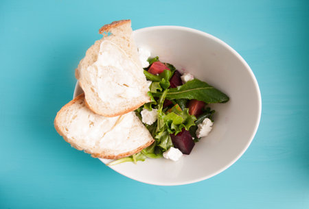 beet and goat cheese salad with home made breadの写真素材